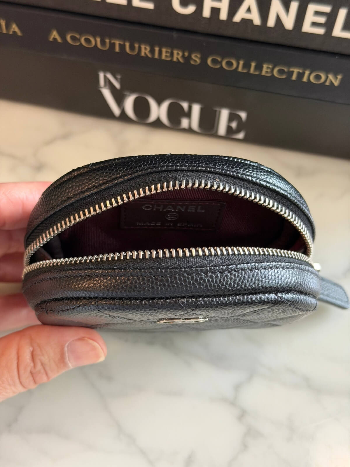 Louise Row featuring Chanel cavier coin purse on table 