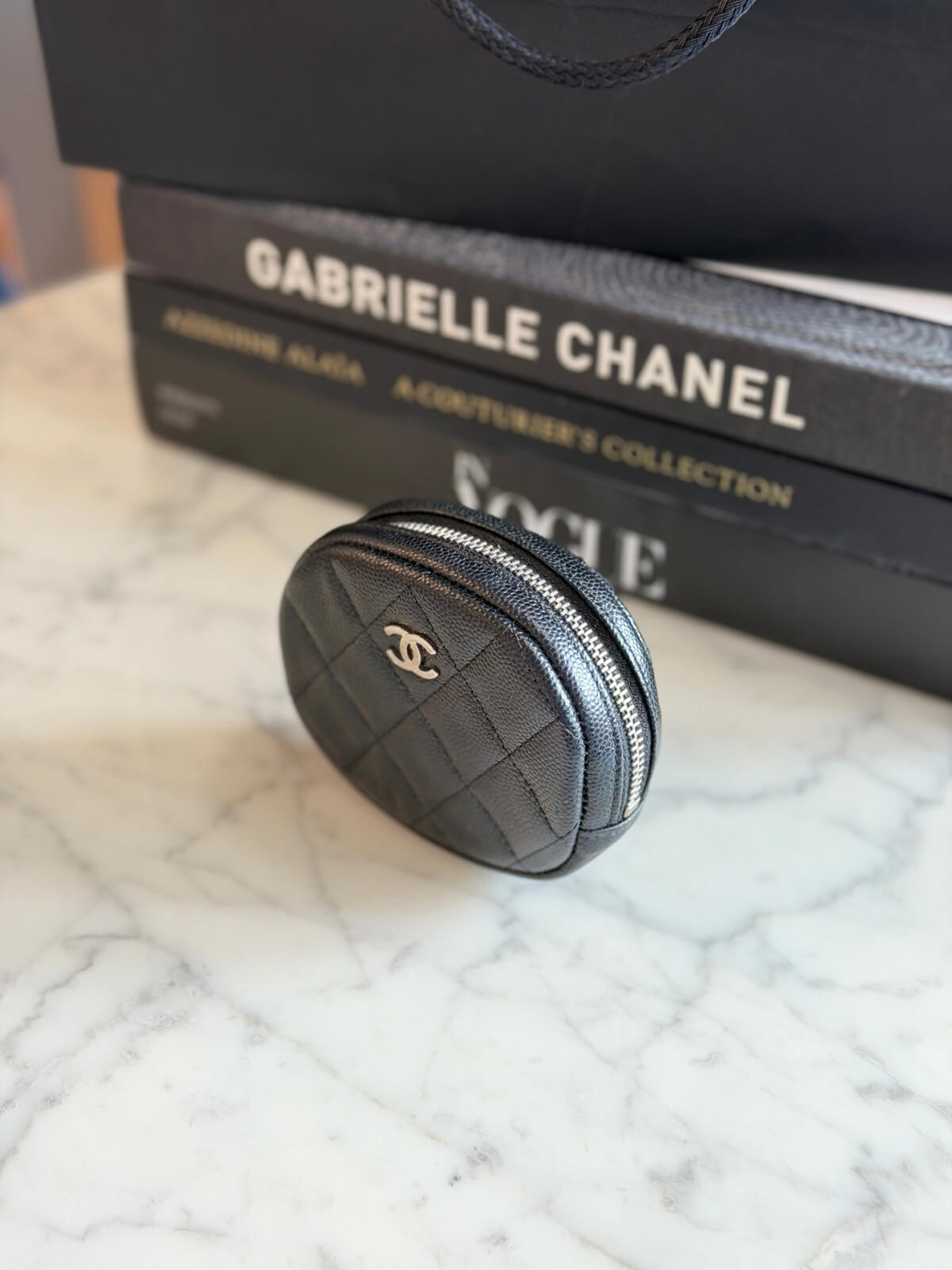 Louise Row featuring Chanel cavier coin purse on table 