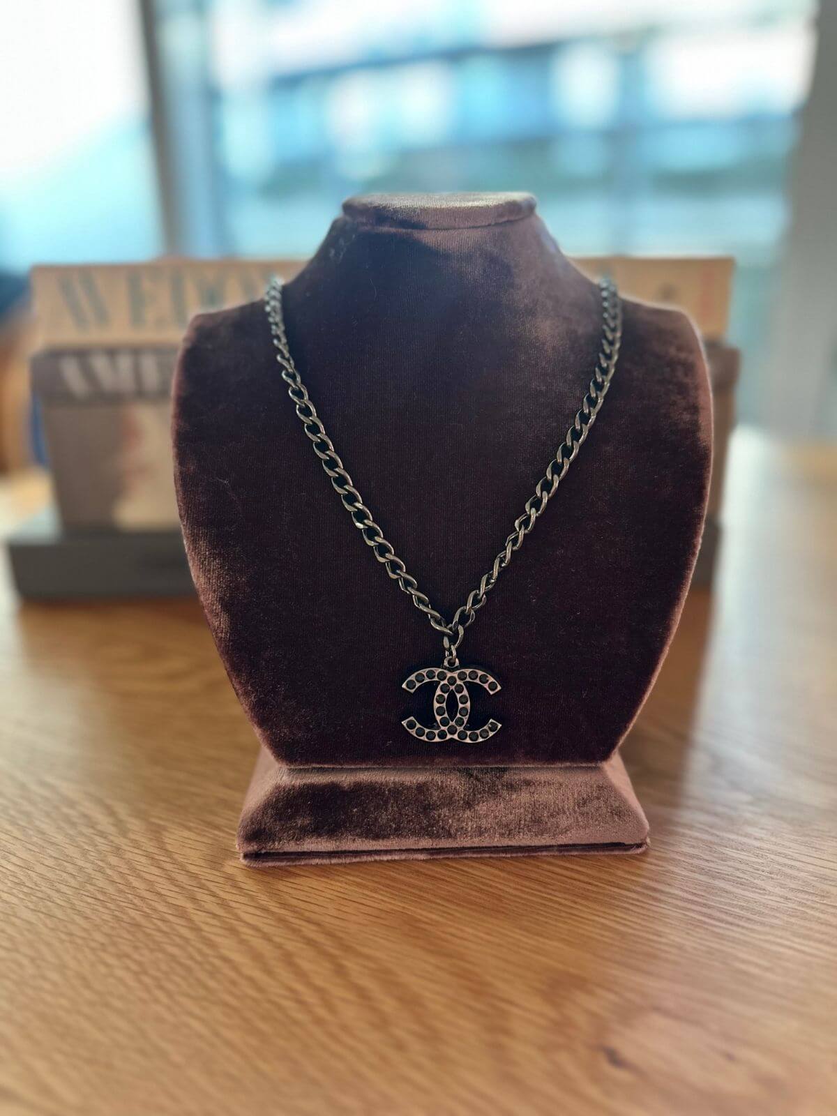 Chanel necklace on brown fixture