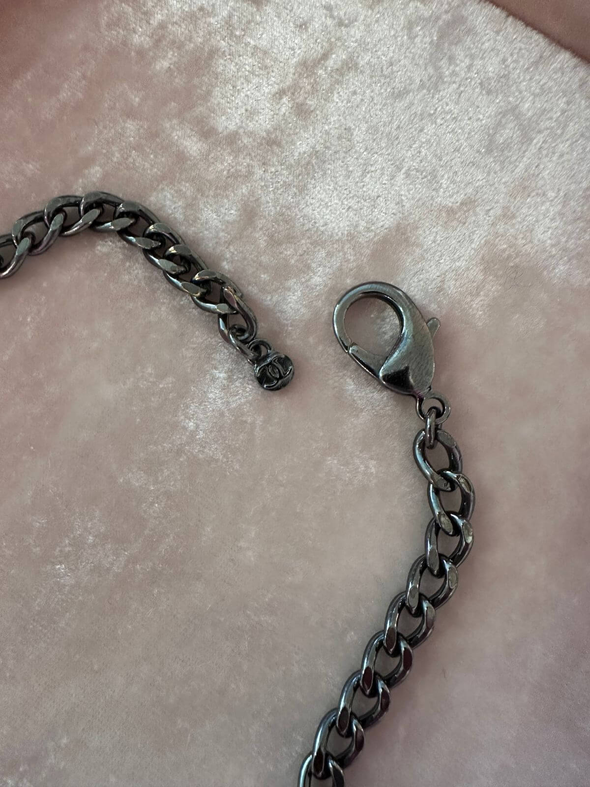 Chanel necklace stamp on pink background