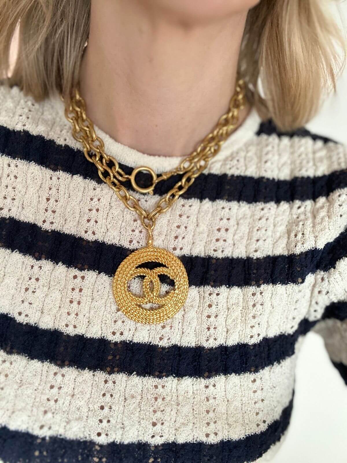 Chanel Logo necklace on model in striped shirt double wrapped
