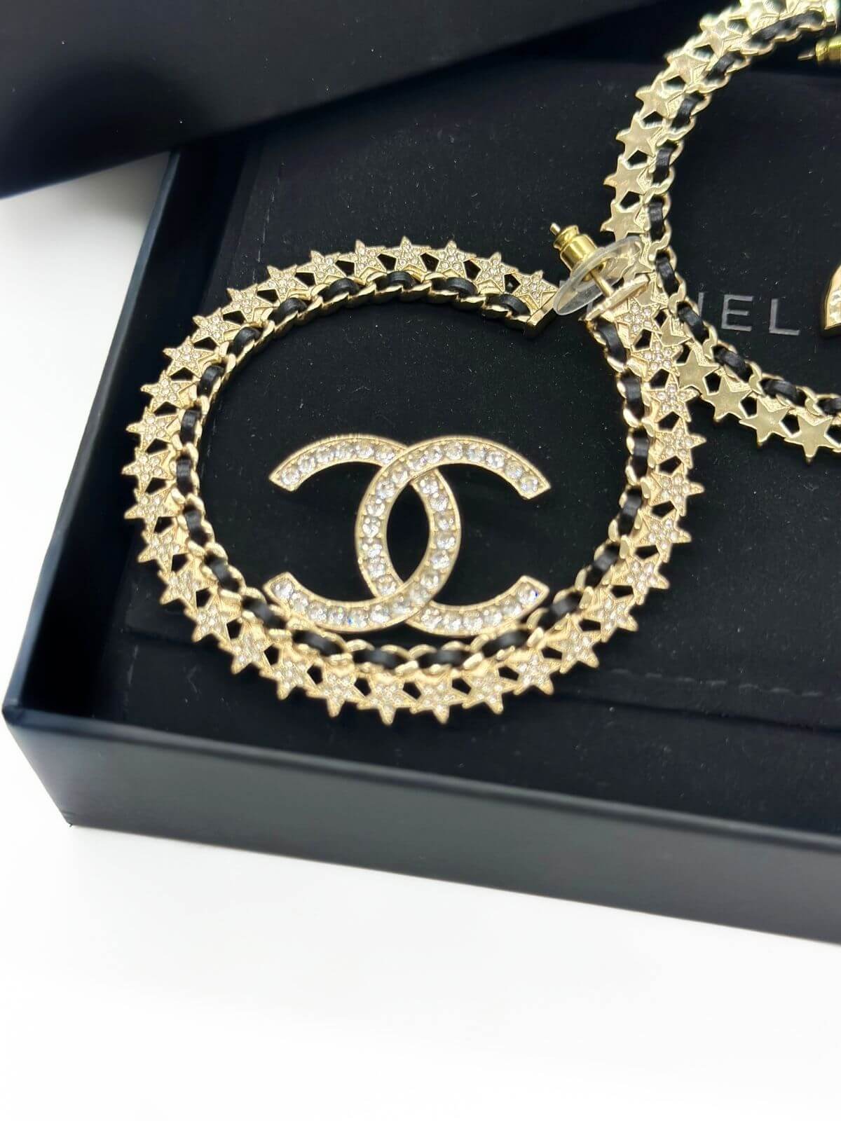 Chanel star hoop earring in black box. Detail