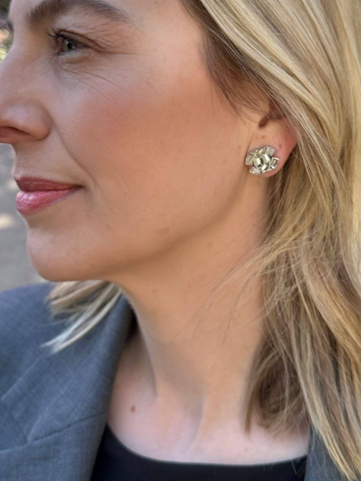 Louise Row Studio crystal Chanel earrings with a CC design on model with blonde hair