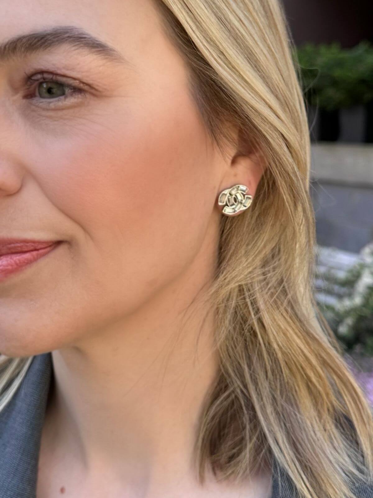 Louise Row Studio crystal Chanel earrings with a CC design on model with blonde hair