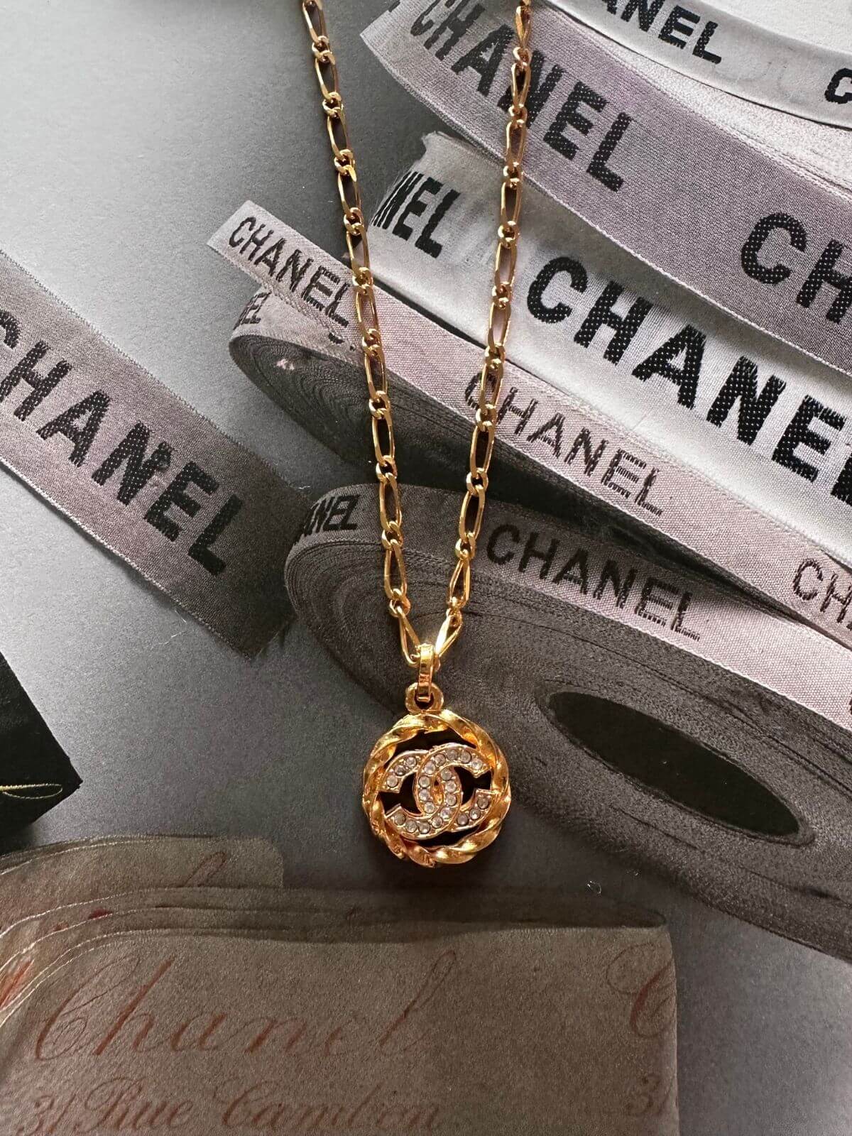 Gold necklace with a pendant on Chanel packaging