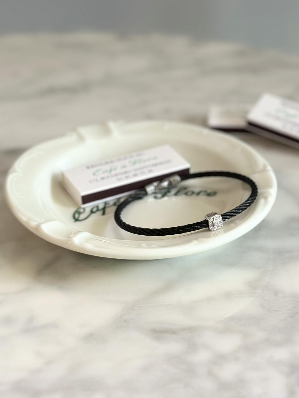Louise Row Studio featuring Charriol black PVD bracelet on plate