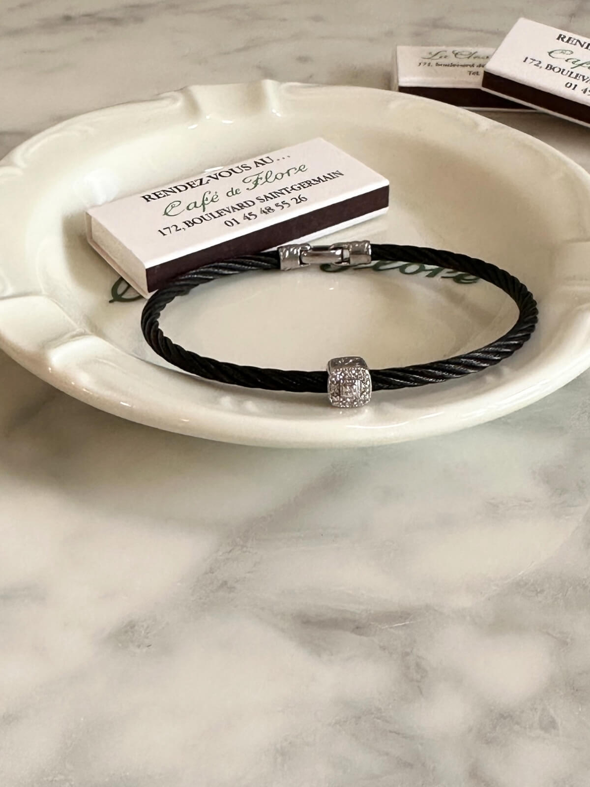 Louise Row Studio featuring Charriol black PVD bracelet on plate
