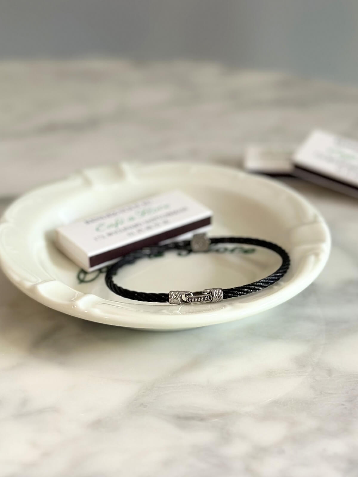 Louise Row Studio featuring Charriol black PVD bracelet on plate