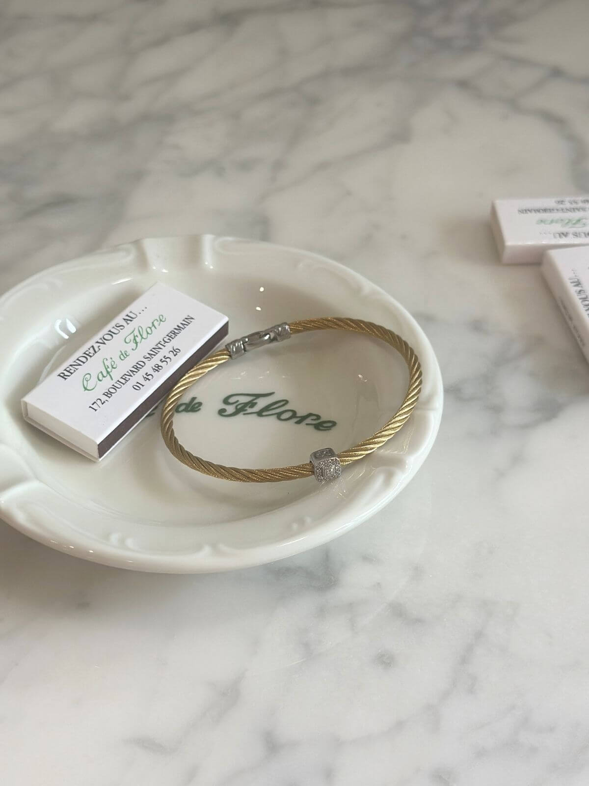 Louise Row Studio featuring Charriol cable bracelet on plate on grey table. 