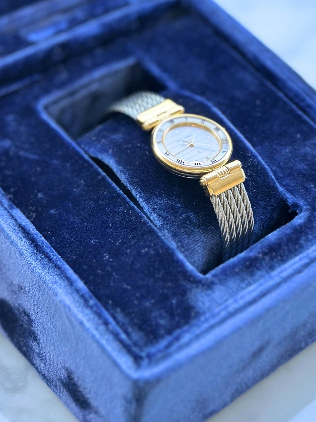 Louise Row Studio featuring Charriol 2-tone watch in blue display box.