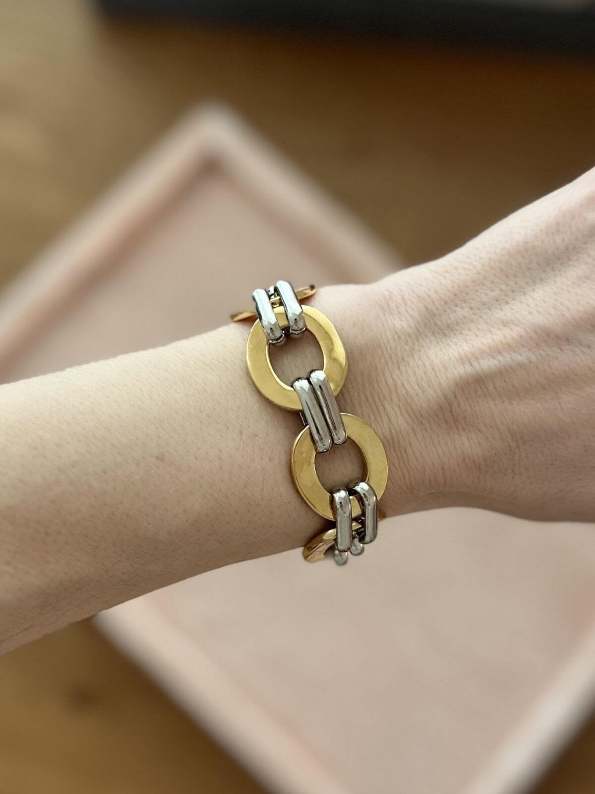 Chloe bracelet on pink display with lock charms on arm