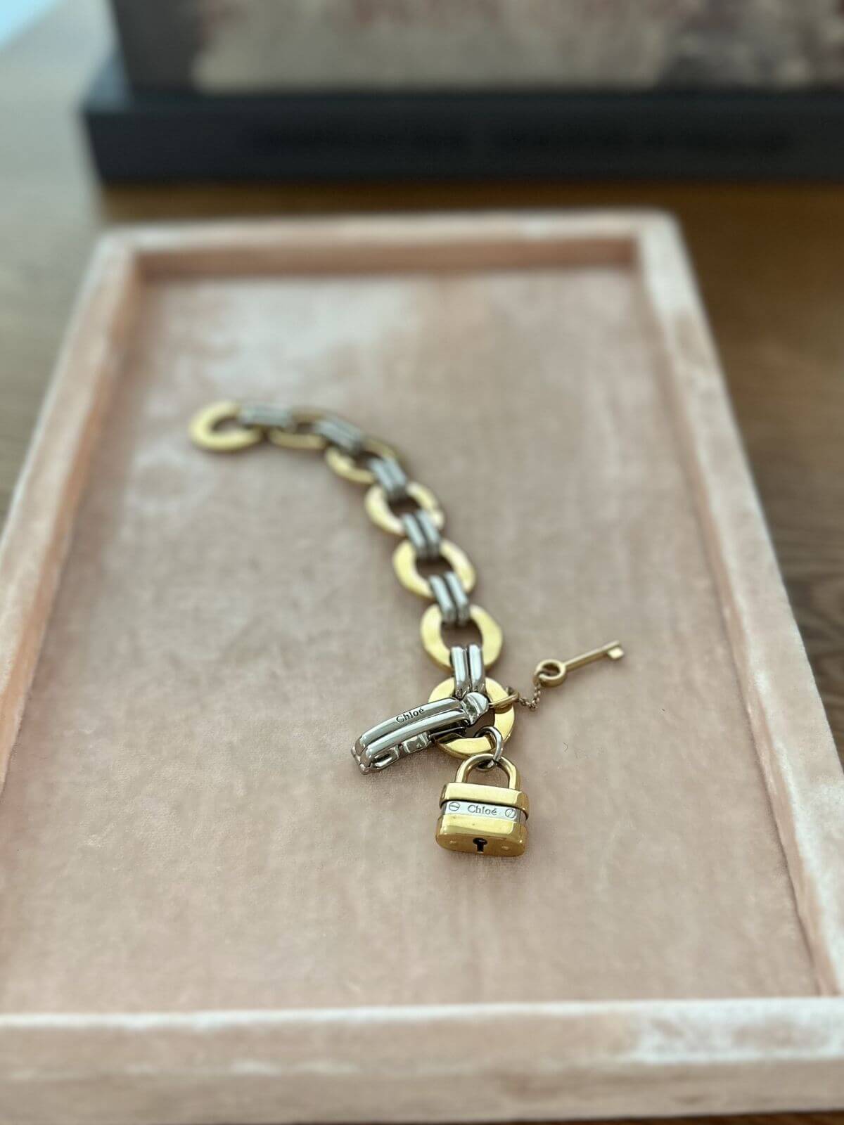 Chloe bracelet on pink display with lock charms