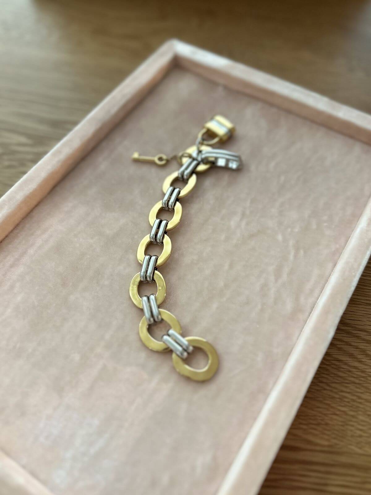 Chloe bracelet on pink display with lock charms 