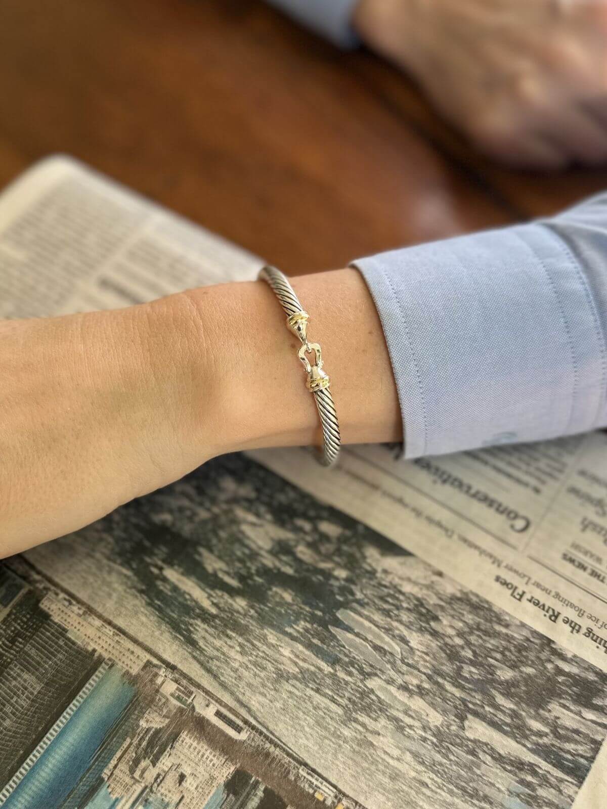 Silver bracelet on a wrist with a blurred background