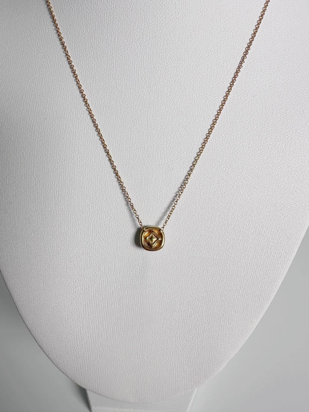 Back of DY Gold necklace on a mannequin with a white background