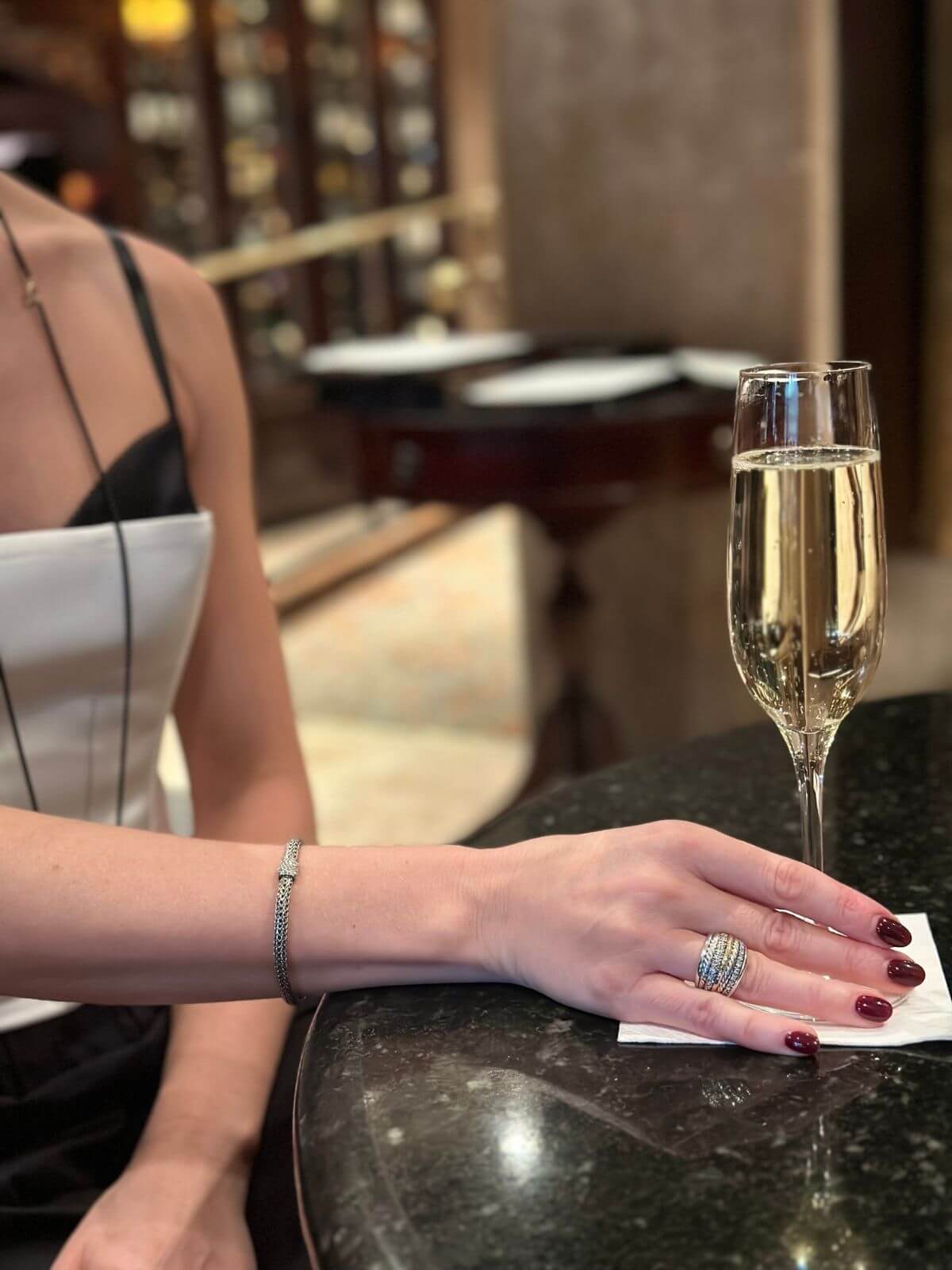Model holding glass of champage with David yurman ring on