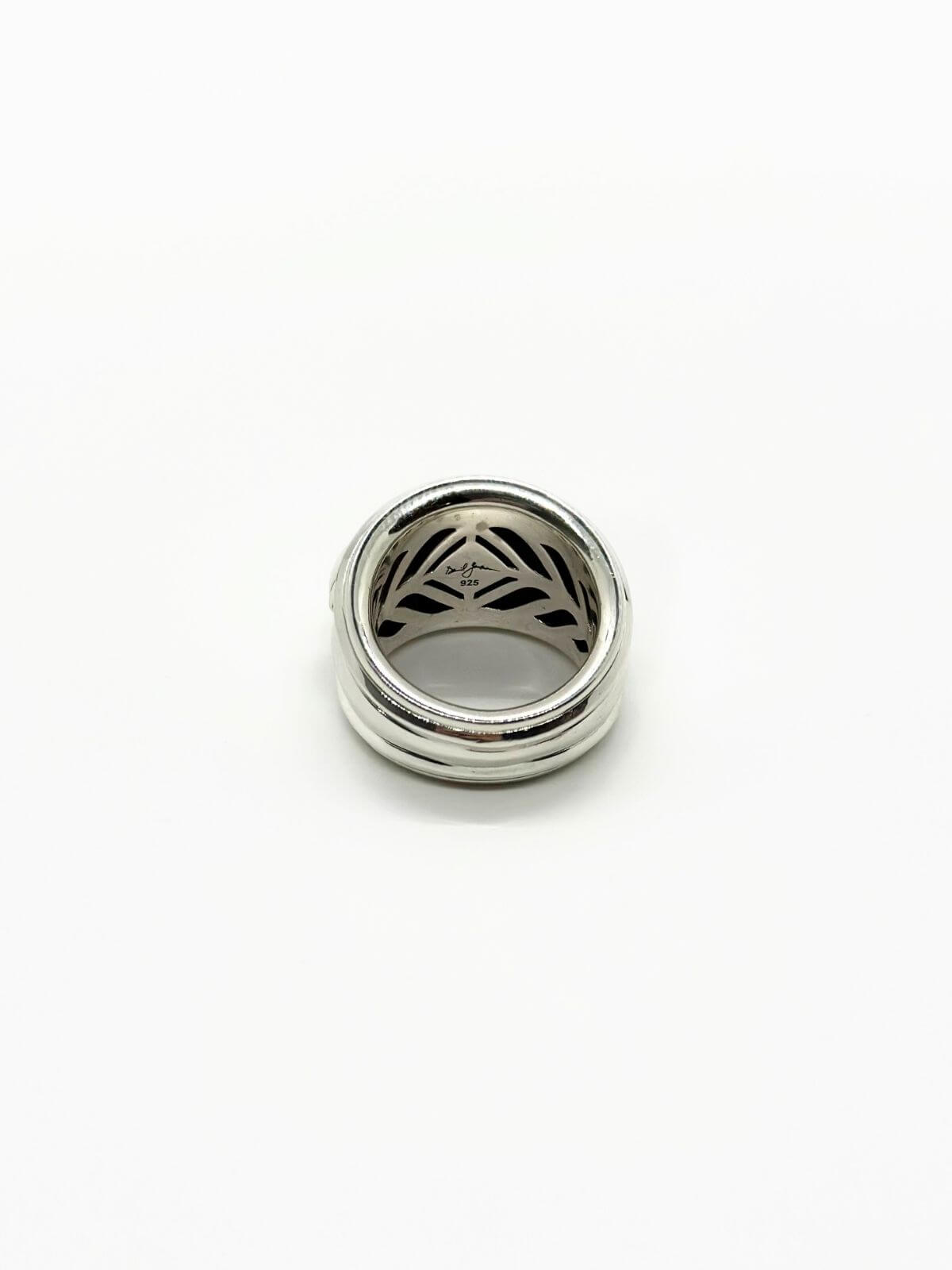DY Renaissance ring in sterling silver on white background with signature on back.