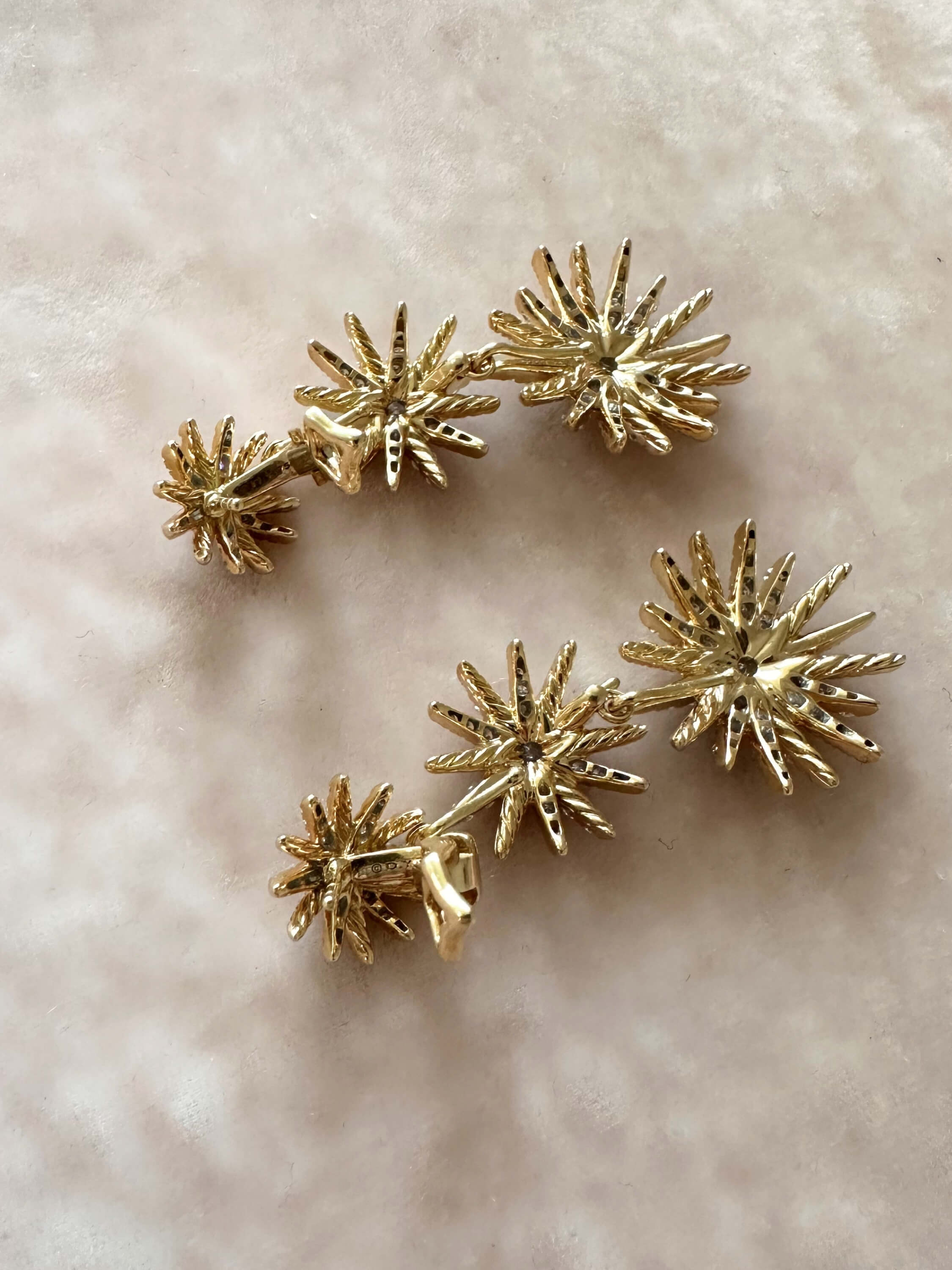 Louise Row Studio David Yurman 18K and diamond Starburst earrings, 3 drop convertible design on pink background. 