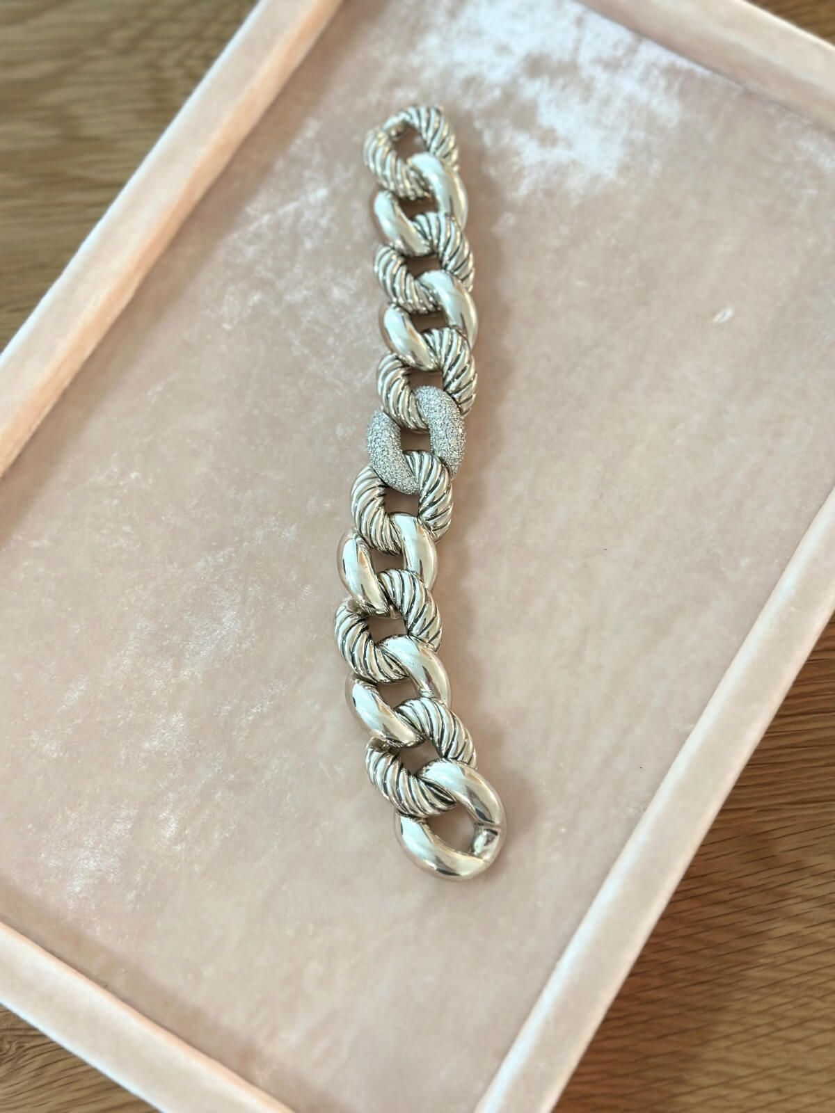 Louise Row Studio featuring David Yurman belmont bracelet made of large link in silver with diamond center station on pink pad. 