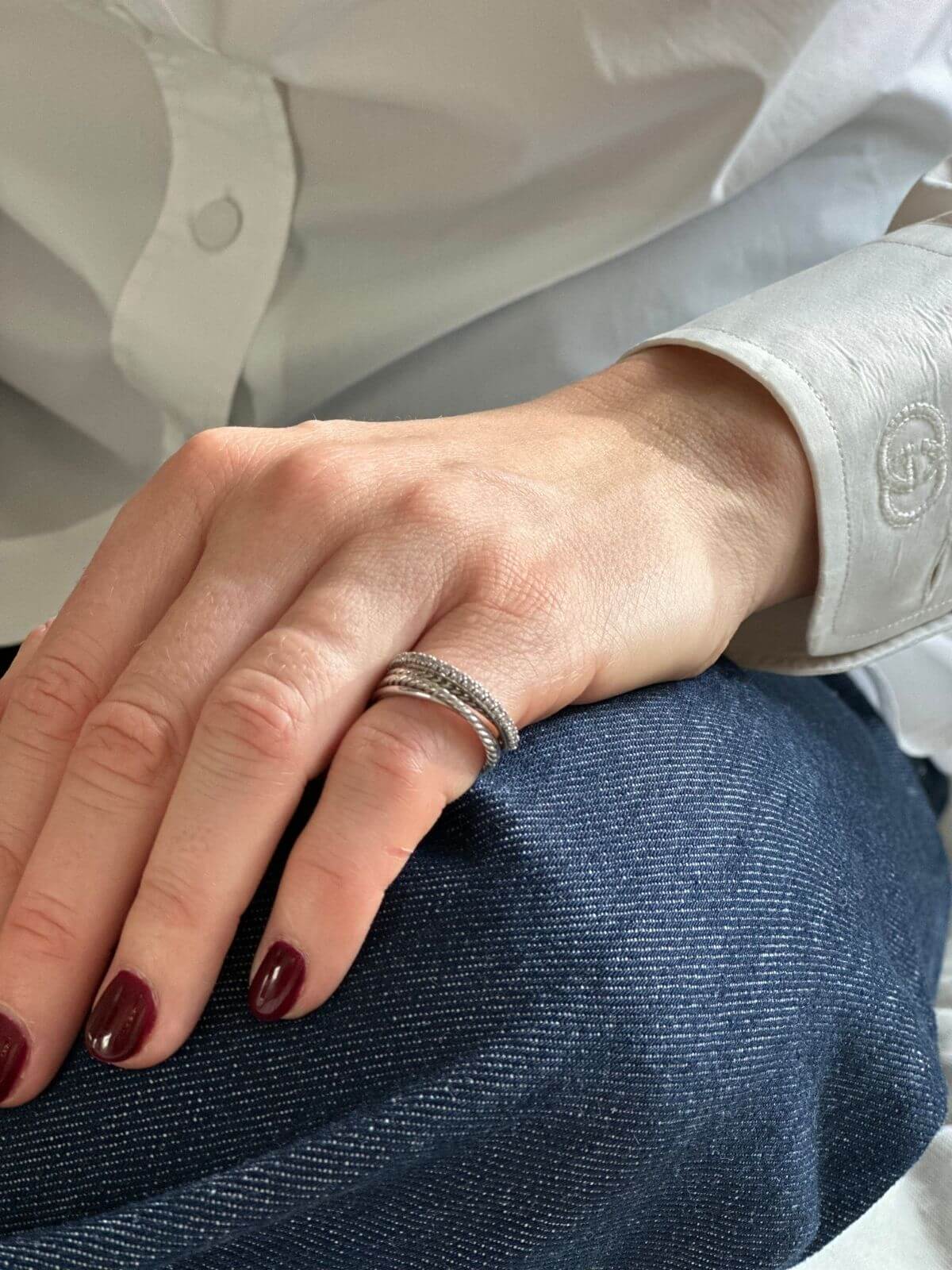 David Yurman silver Crossover ring on pinky finger of model with hand on jeans