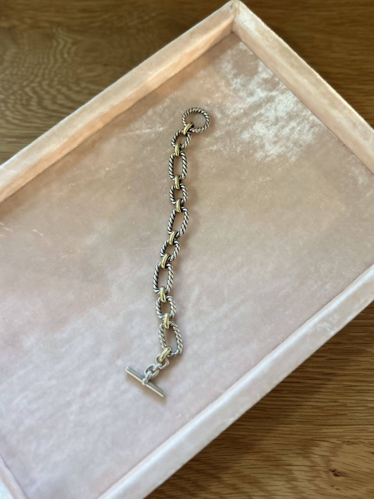 David Yurman gold and silver toggle bracelet full view on pink fixture