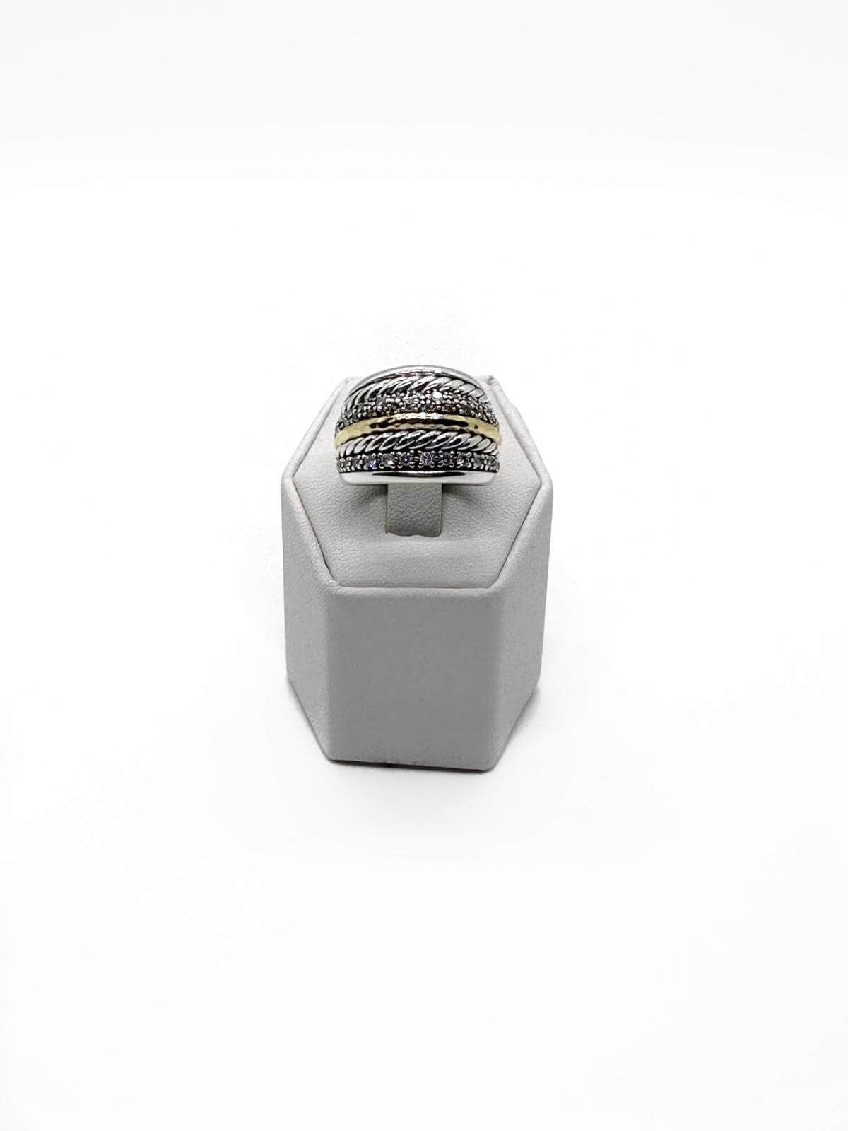 David Yurman silver and diamond ring on grey fixture on white background.