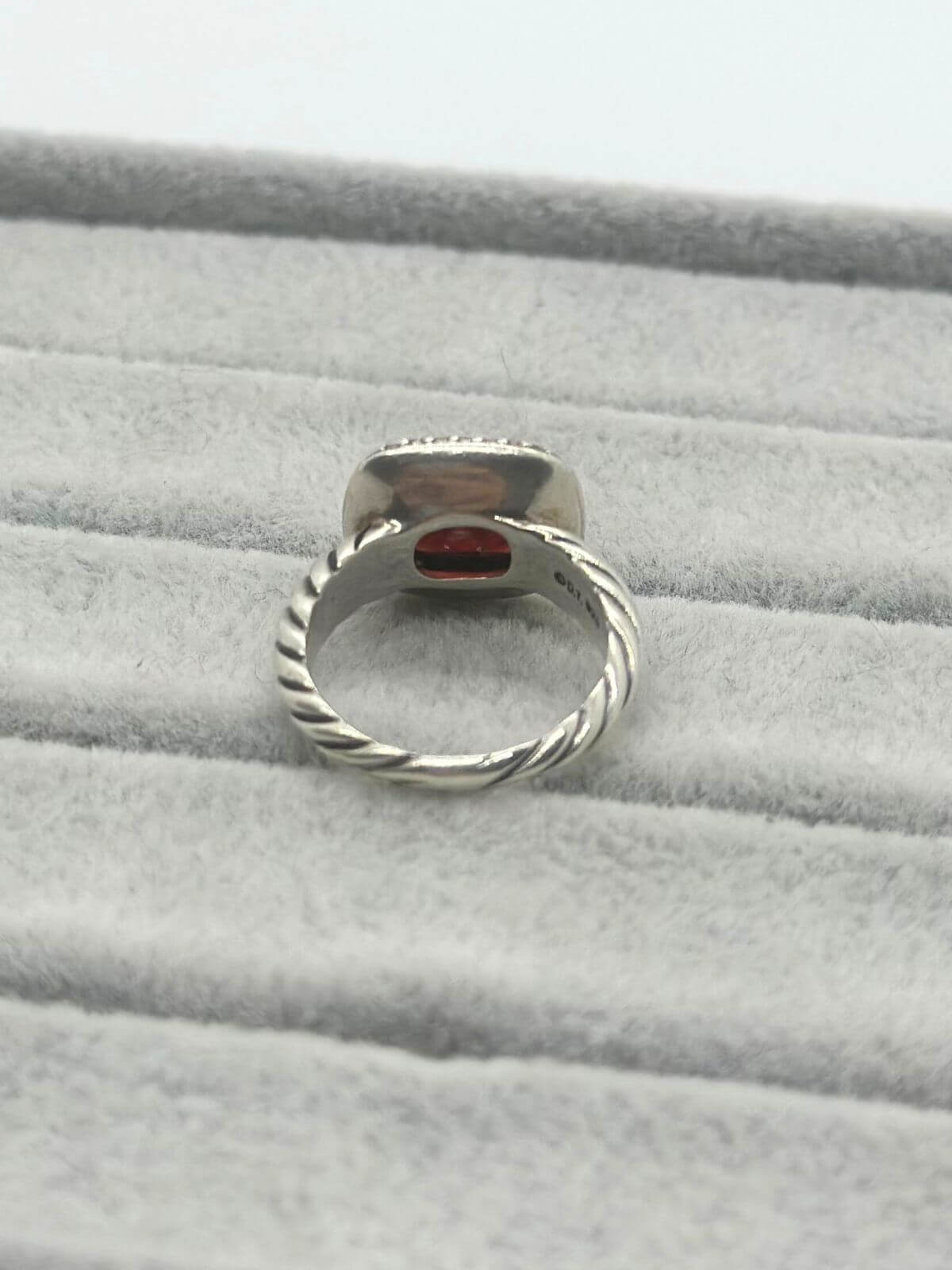 David Yurman Petite Noblesse Ring on grey fixture garnet and dia ring with silver. 