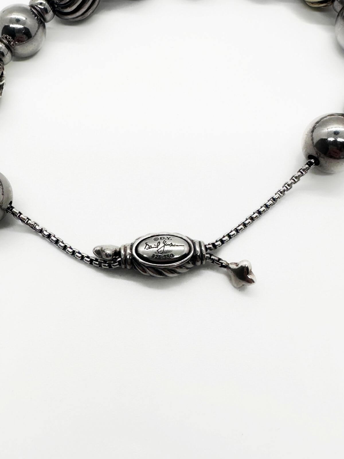 David Yurman silver bead bracelet on white background. showing signature .