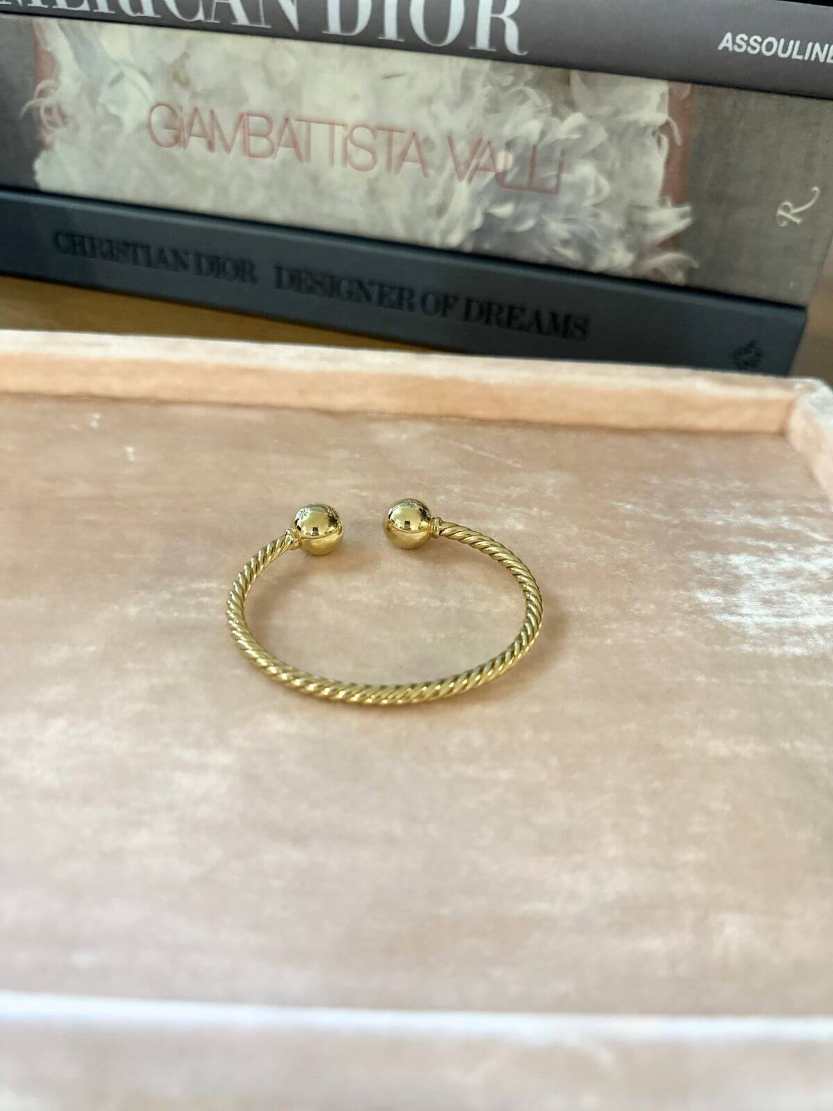 Gold David Yurman Solari bracelet on pink tray back