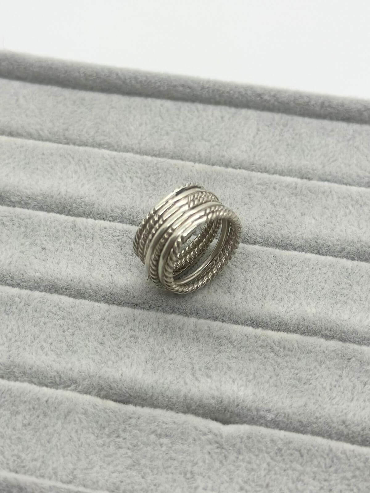 Silver David Yurman Crossover Ring with dia on grey background