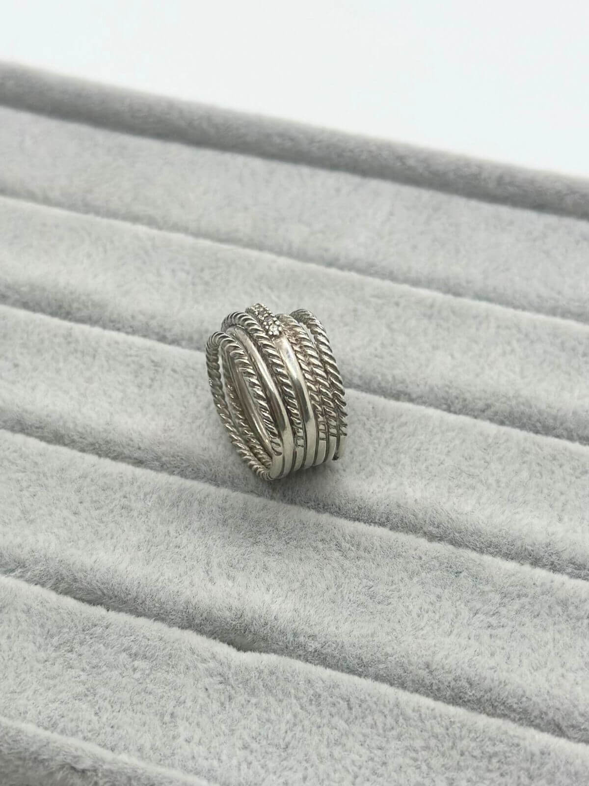 Silver David Yurman Crossover Ring with dia on grey background
