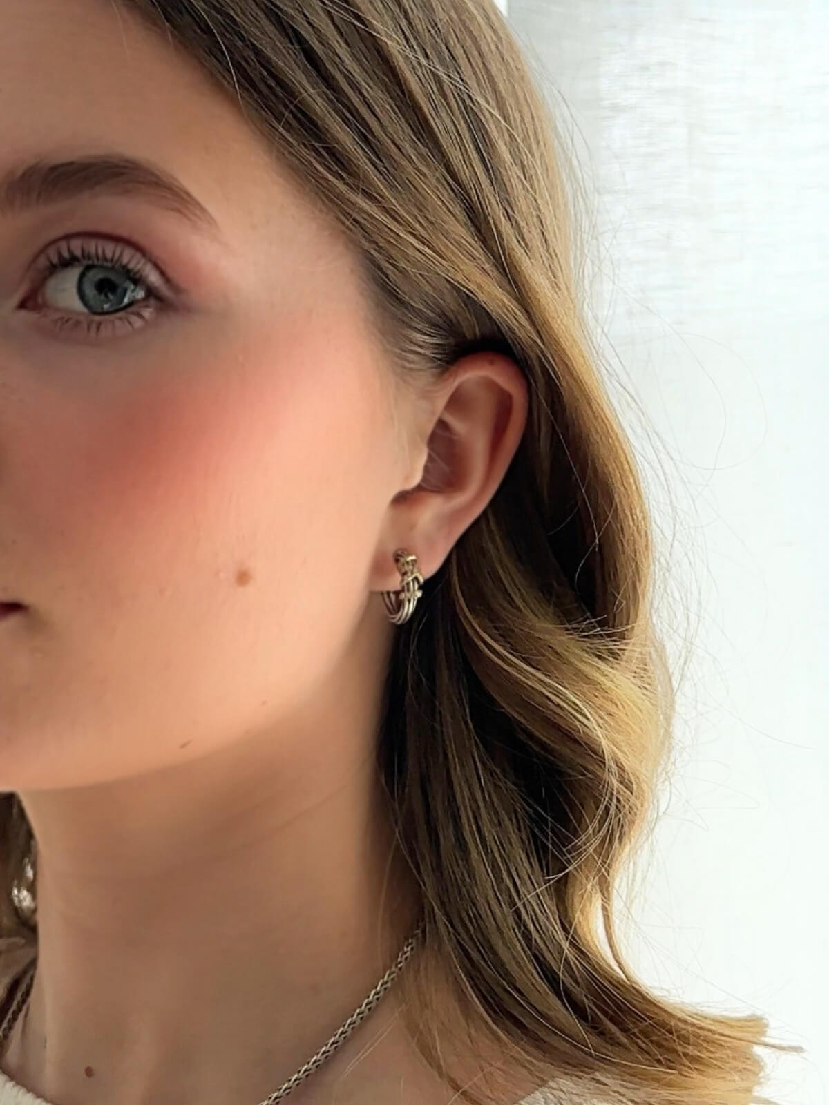 Louise Row Studio featuring David yurman Helena 2 tone small hoop earrings on close-up of model