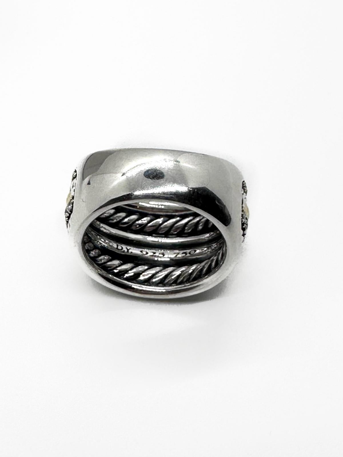 Back of David Yurman silver and diamond ring showing signature on white background.