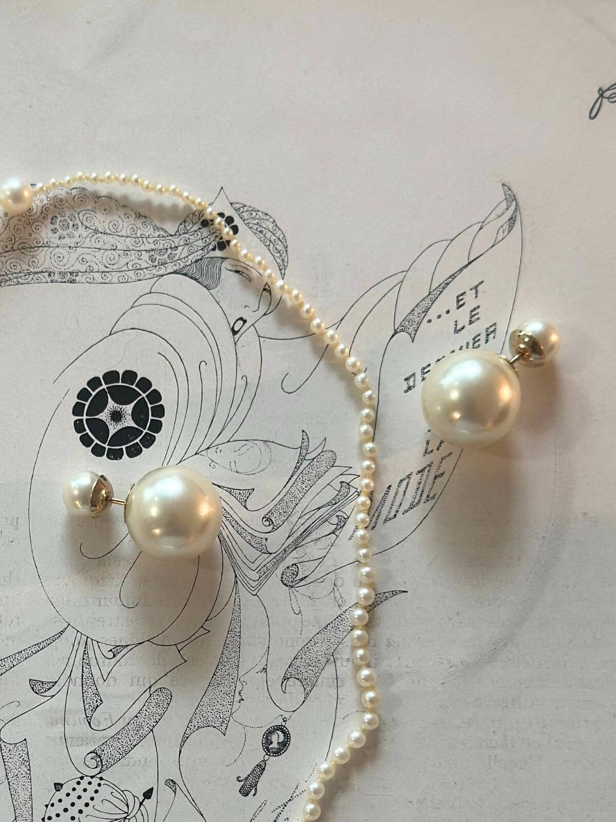 Dior pearl earrings on paper