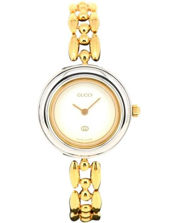 Gold Gucci watch with a white face on a white background