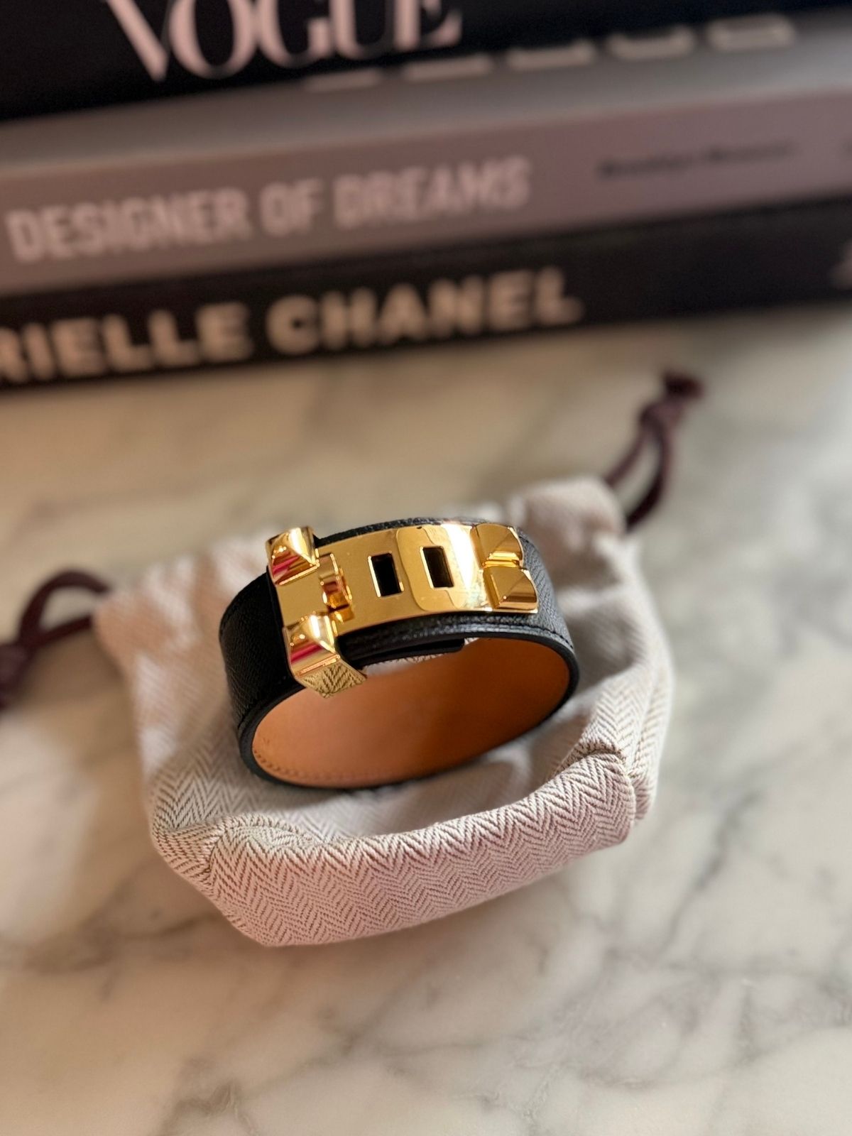 Louise Row featuring Hermes Collier Cuff 24 in black leather on table