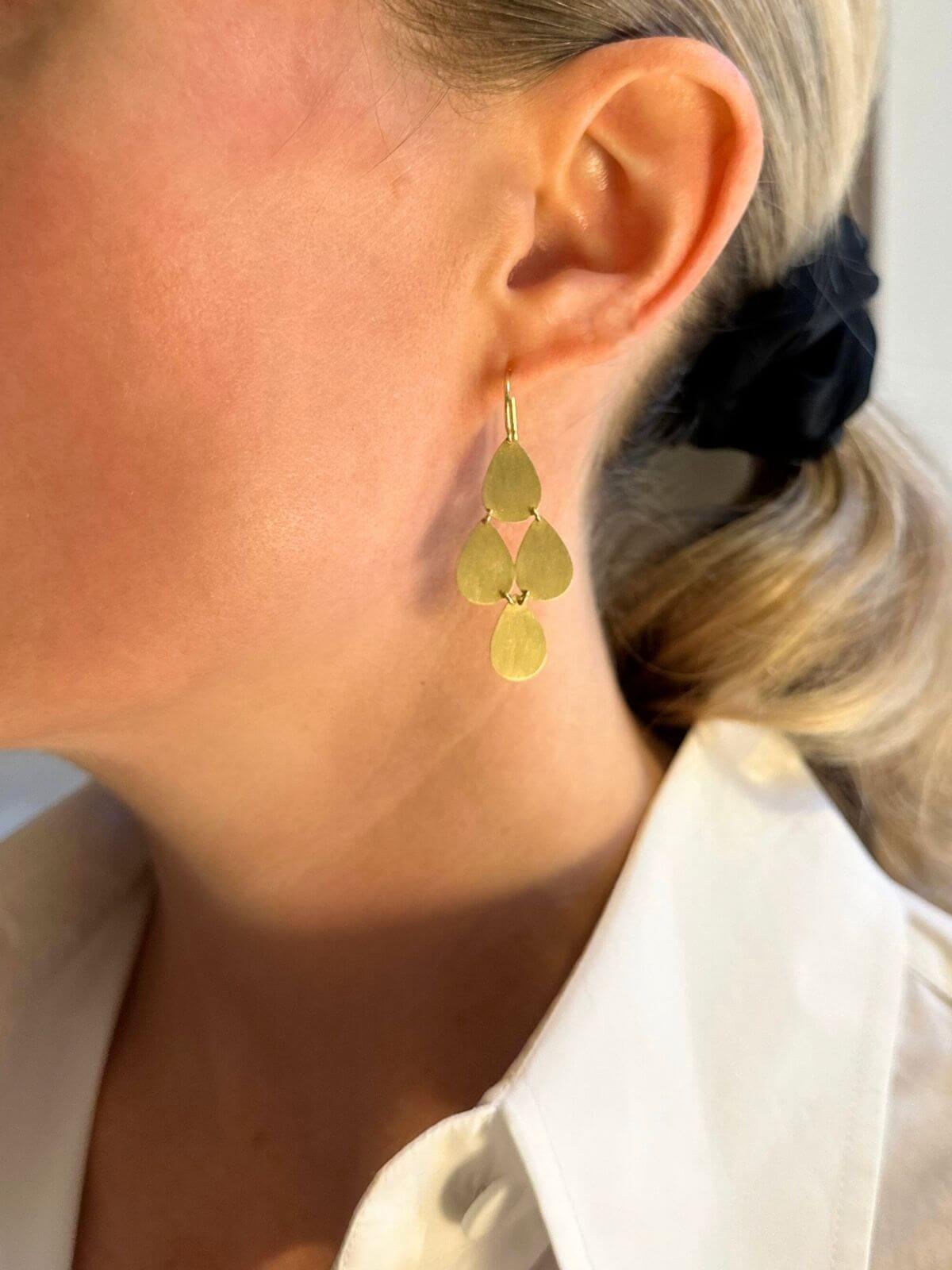 Louise Row Studio featuring Irene Neuwirth gold drop earrings on model close-up of earrings.