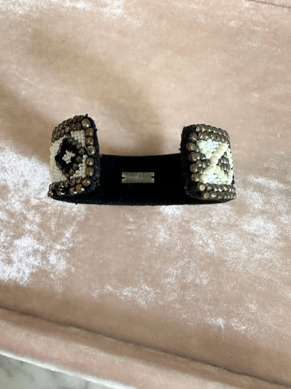 Louise Row Studio featuring Isabel Marant beaded cuff on arm on pink tray