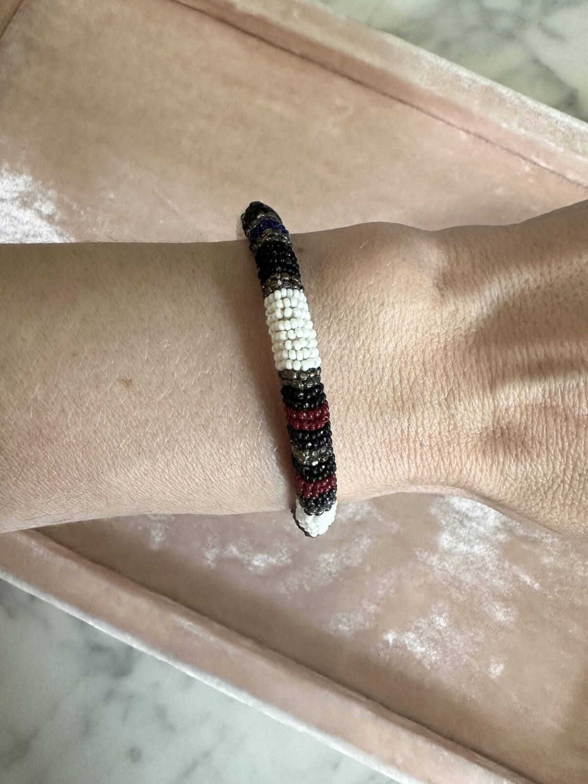 Louise Row Studio featuring Isabel Marant beaded cuff on arm on tray.