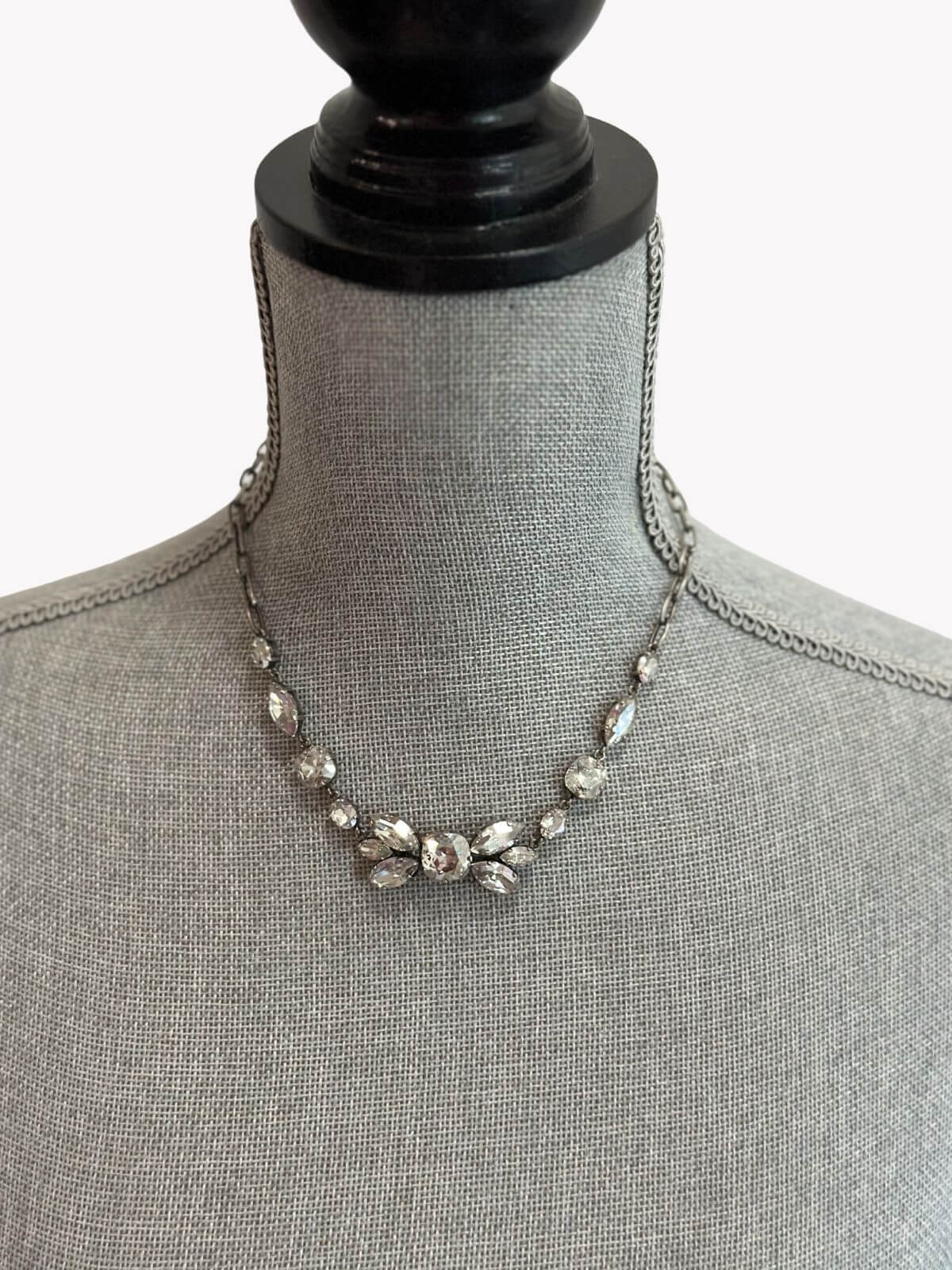 Louise Row Studio featuring Isabel Marant Necklace  with crystals on grey neck mannequin. 