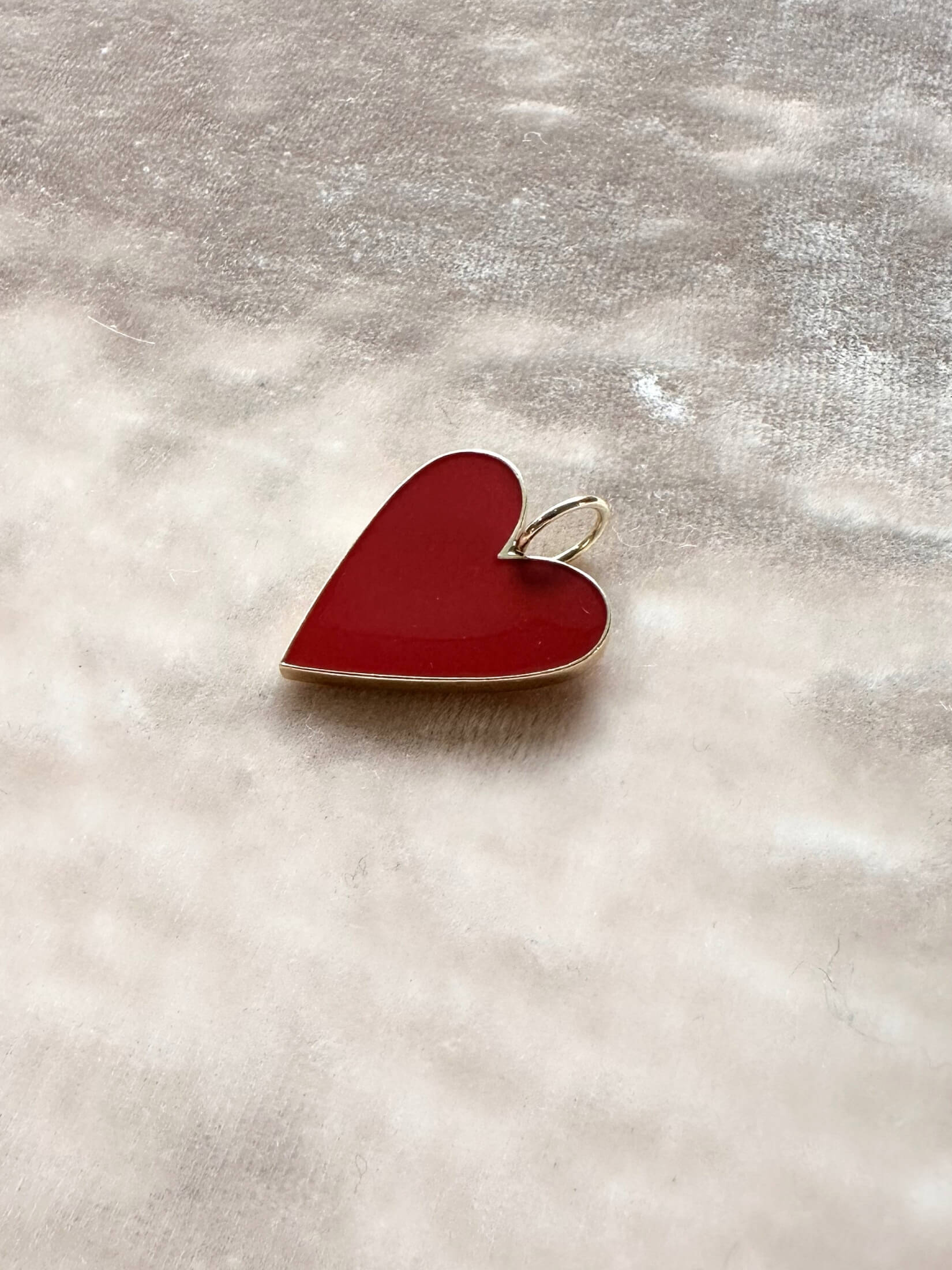 Louise Row Studio featuring Jennifer Fisher enamel heart charm on pink background