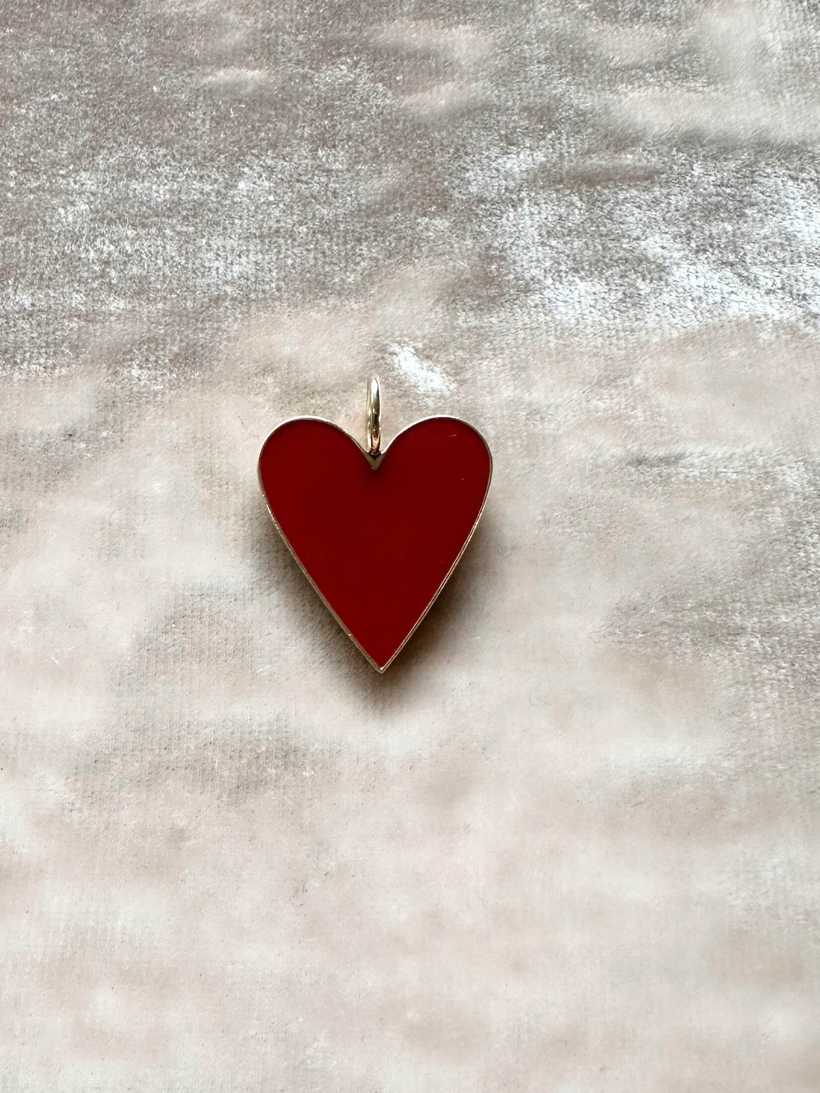 Louise Row Studio featuring Jennifer Fisher enamel heart charm on pink background