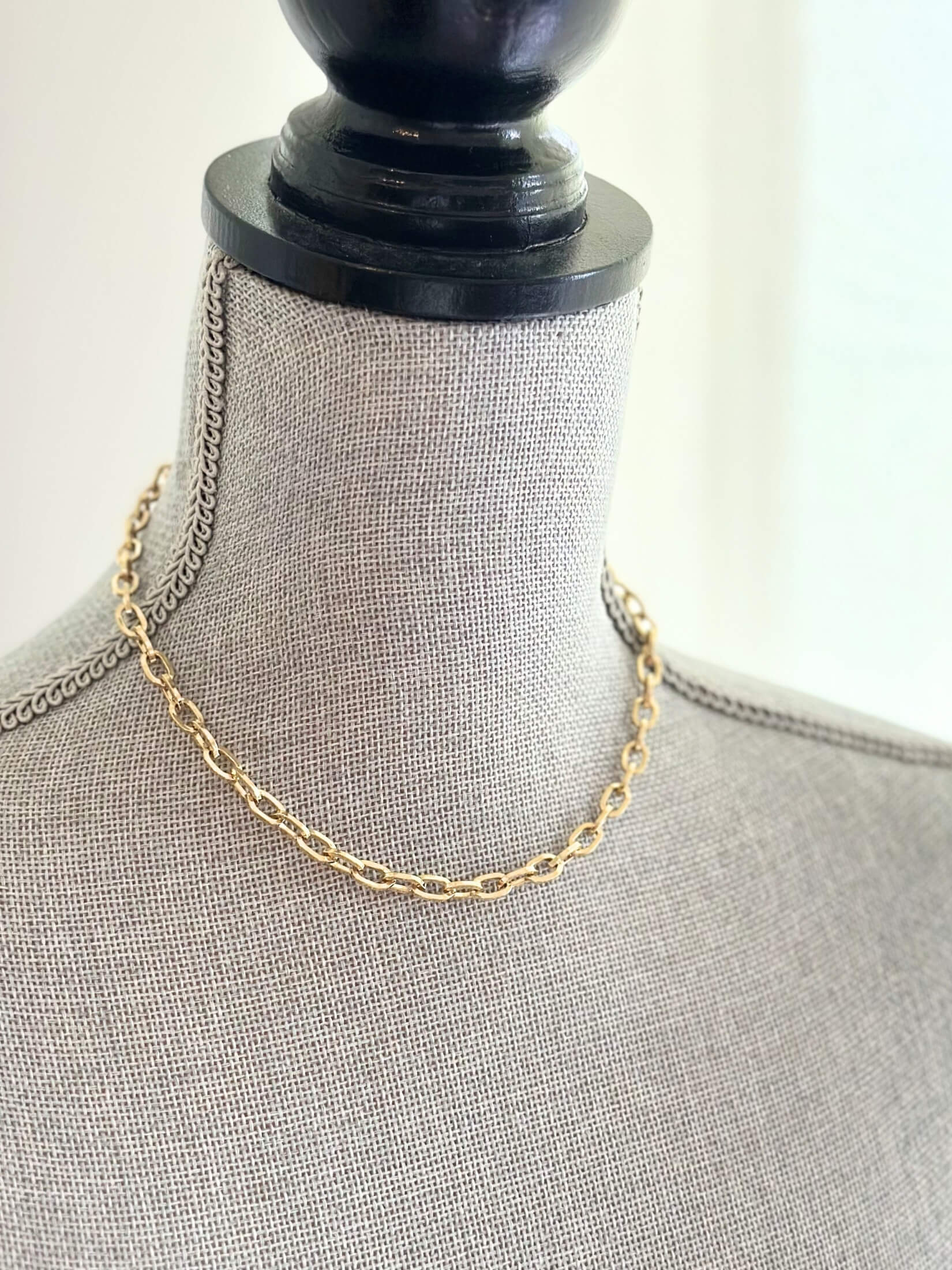 Louise Row featuring Jennifer Fisher XXS gold link chain on grey mannequin