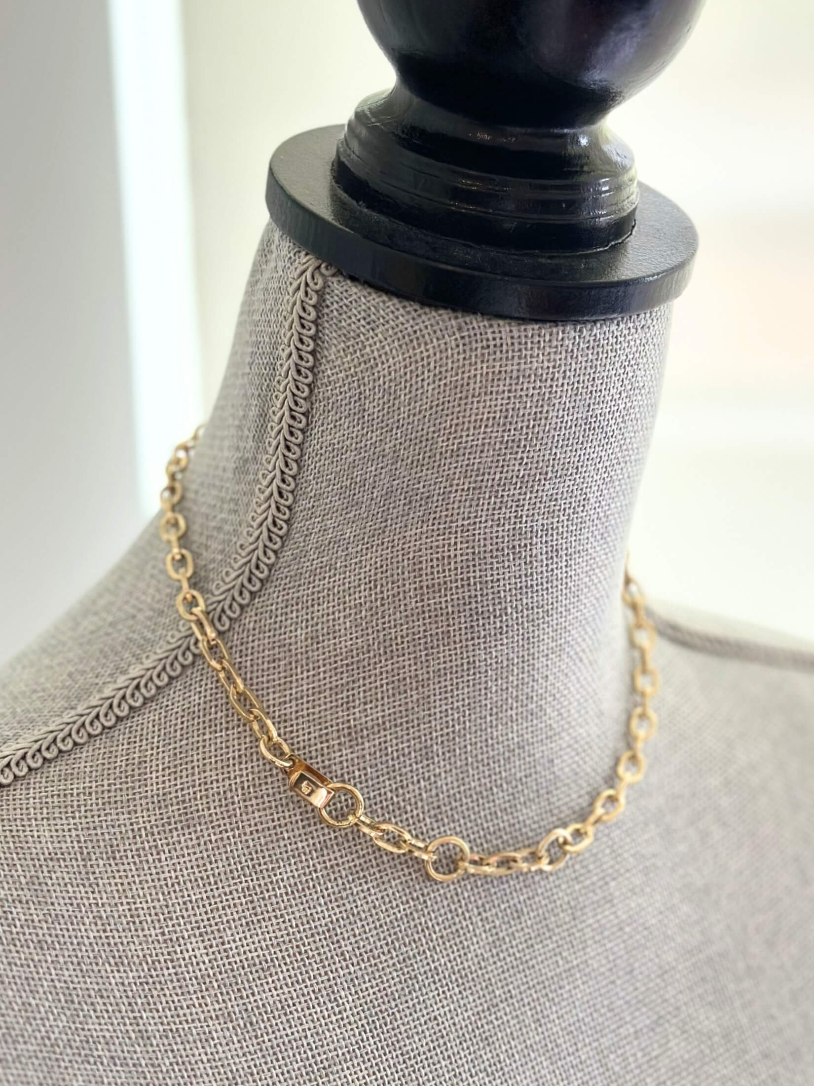 Louise Row featuring Jennifer Fisher XXS gold link chain on grey mannequin