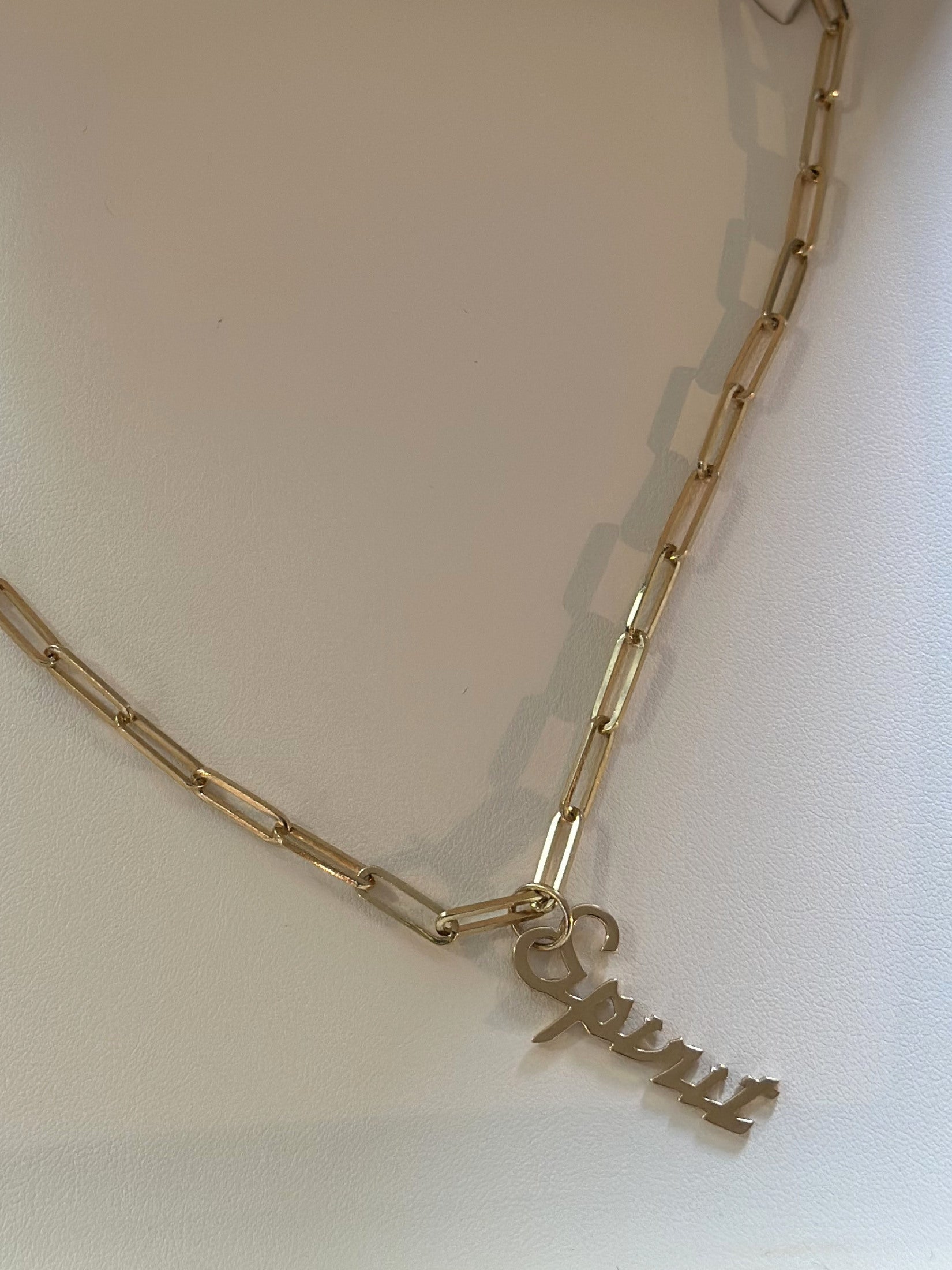 Louise Row featuring gold spirit Jennifer Fisher Charm on necklace in box