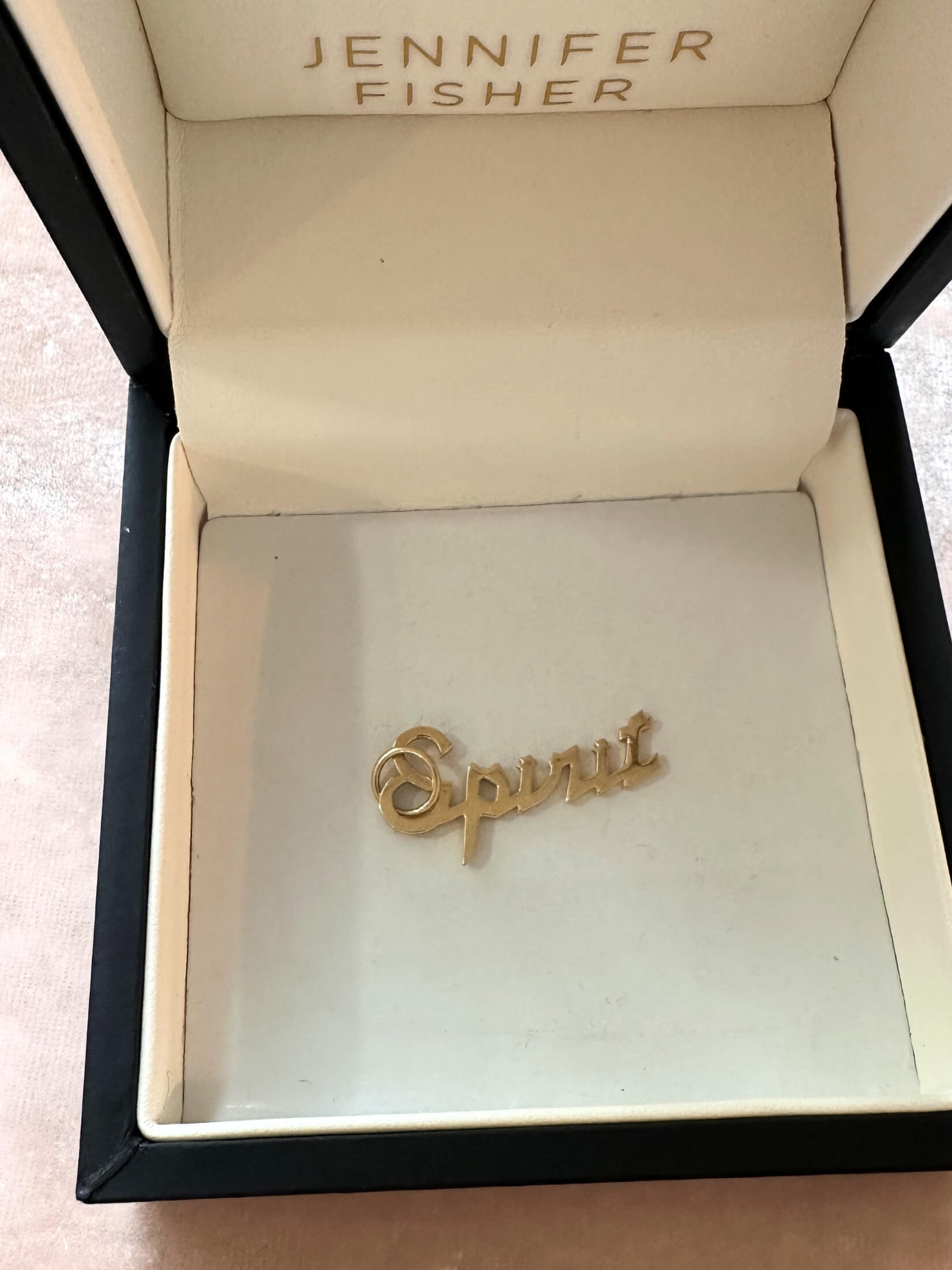 Louise Row featuring gold spirit Jennifer Fisher Charm in box