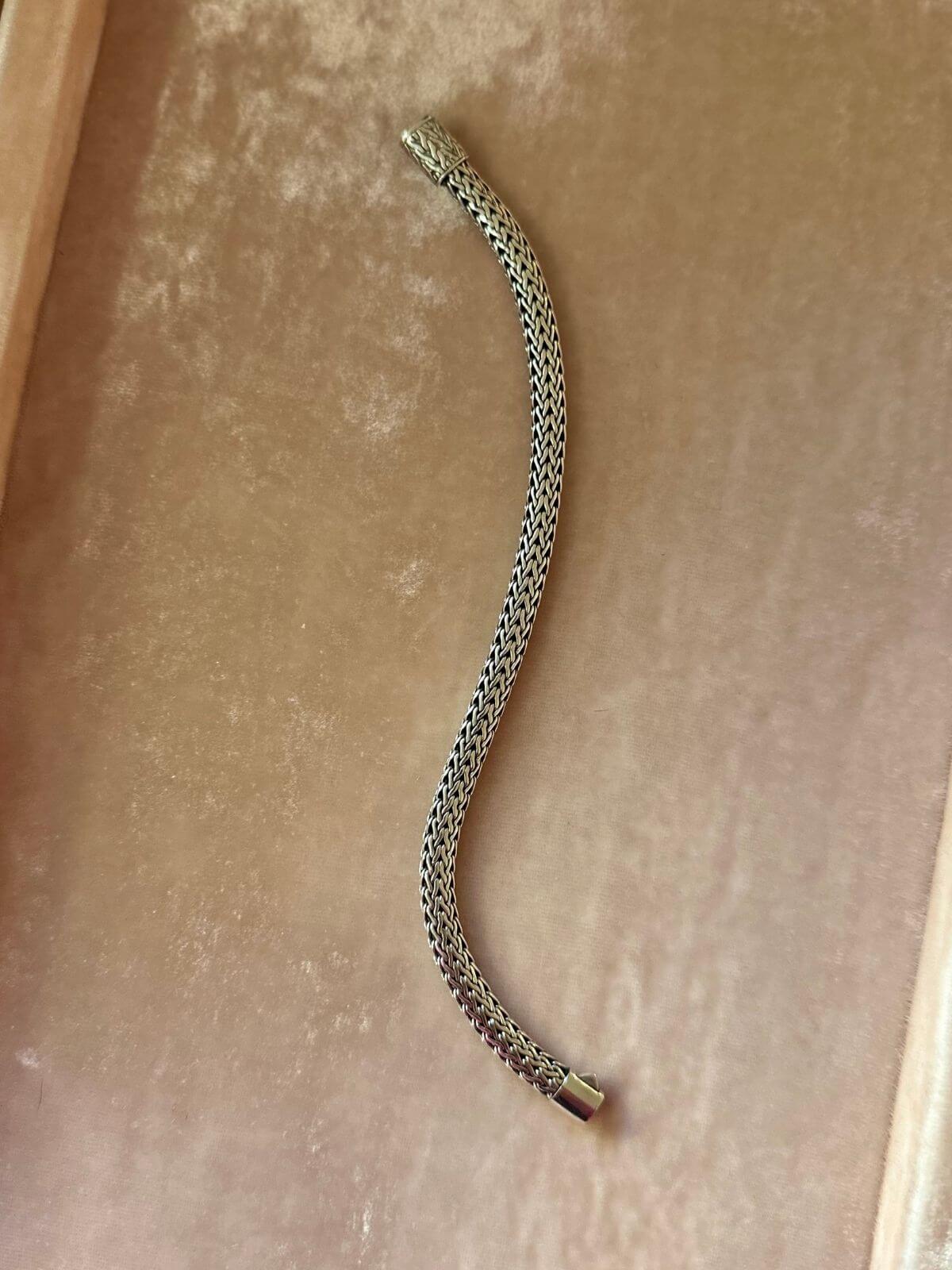 John Hardy Silver bracelet on pink display