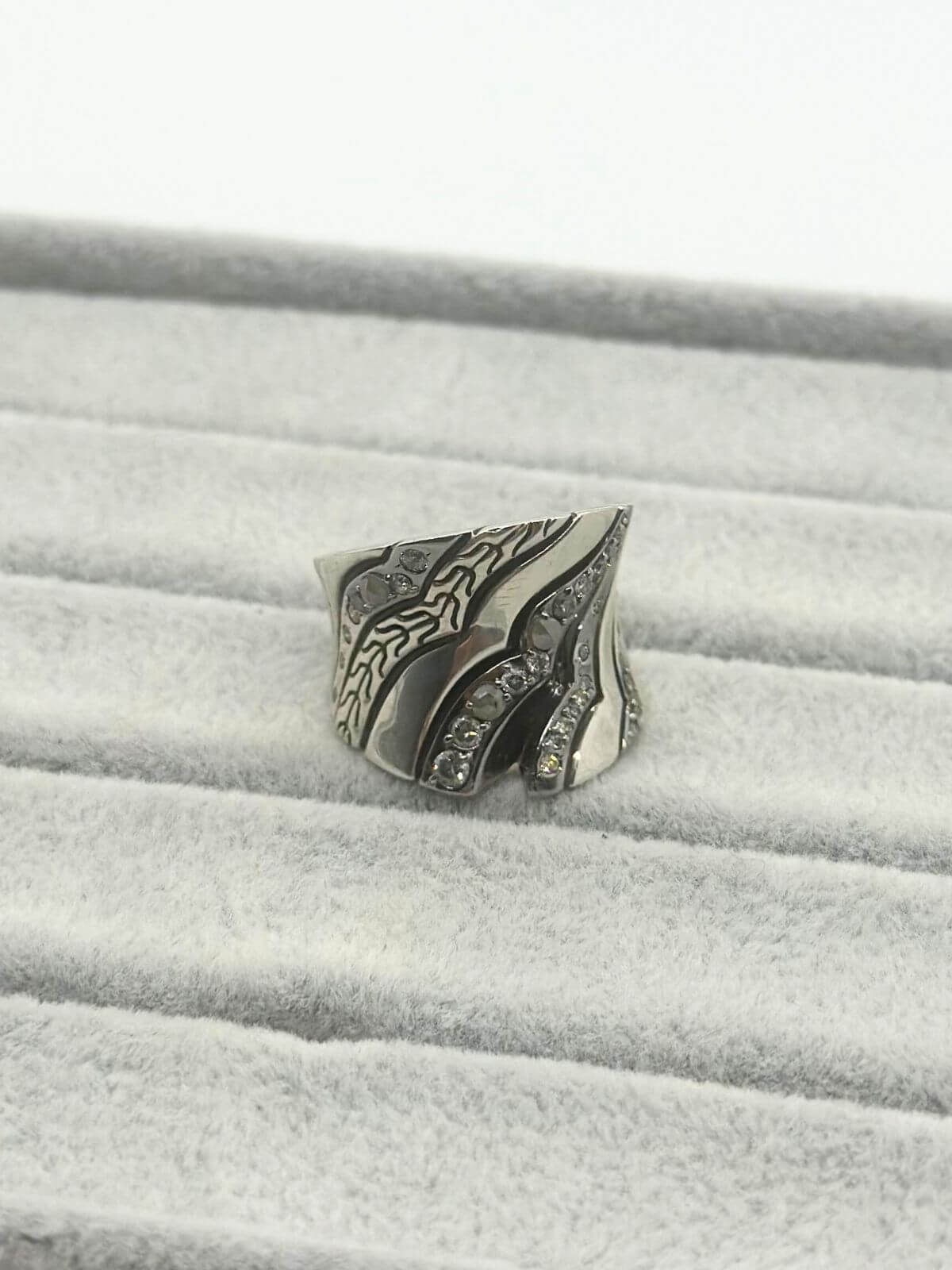 John Hardy silver and diamond ring on grey fixture. 
