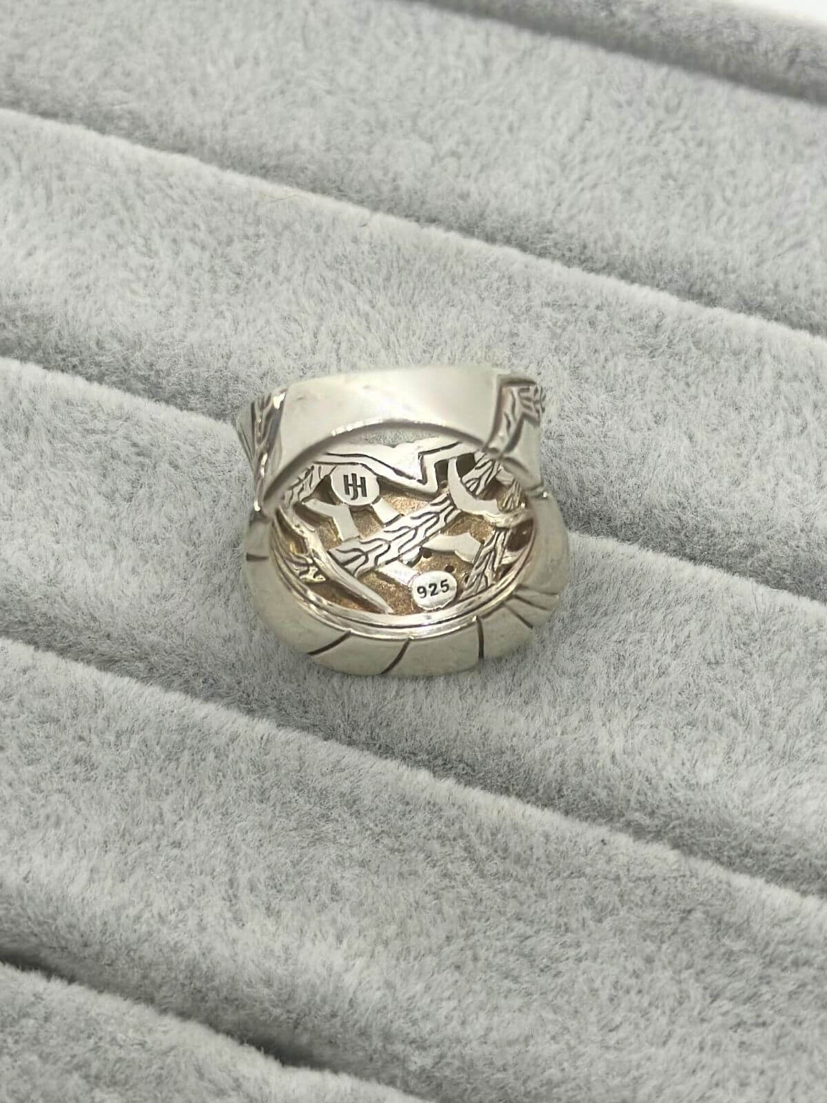 John Hardy silver and diamond ring on grey fixture. Showing stamps on back.