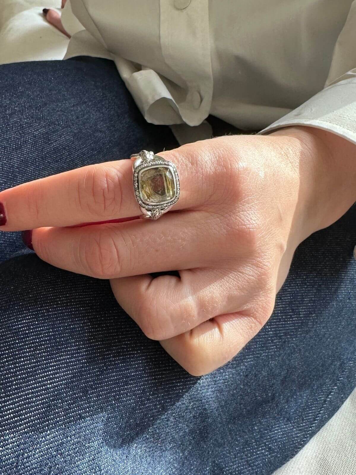 John Hardy quartz ring on model hand on jeans